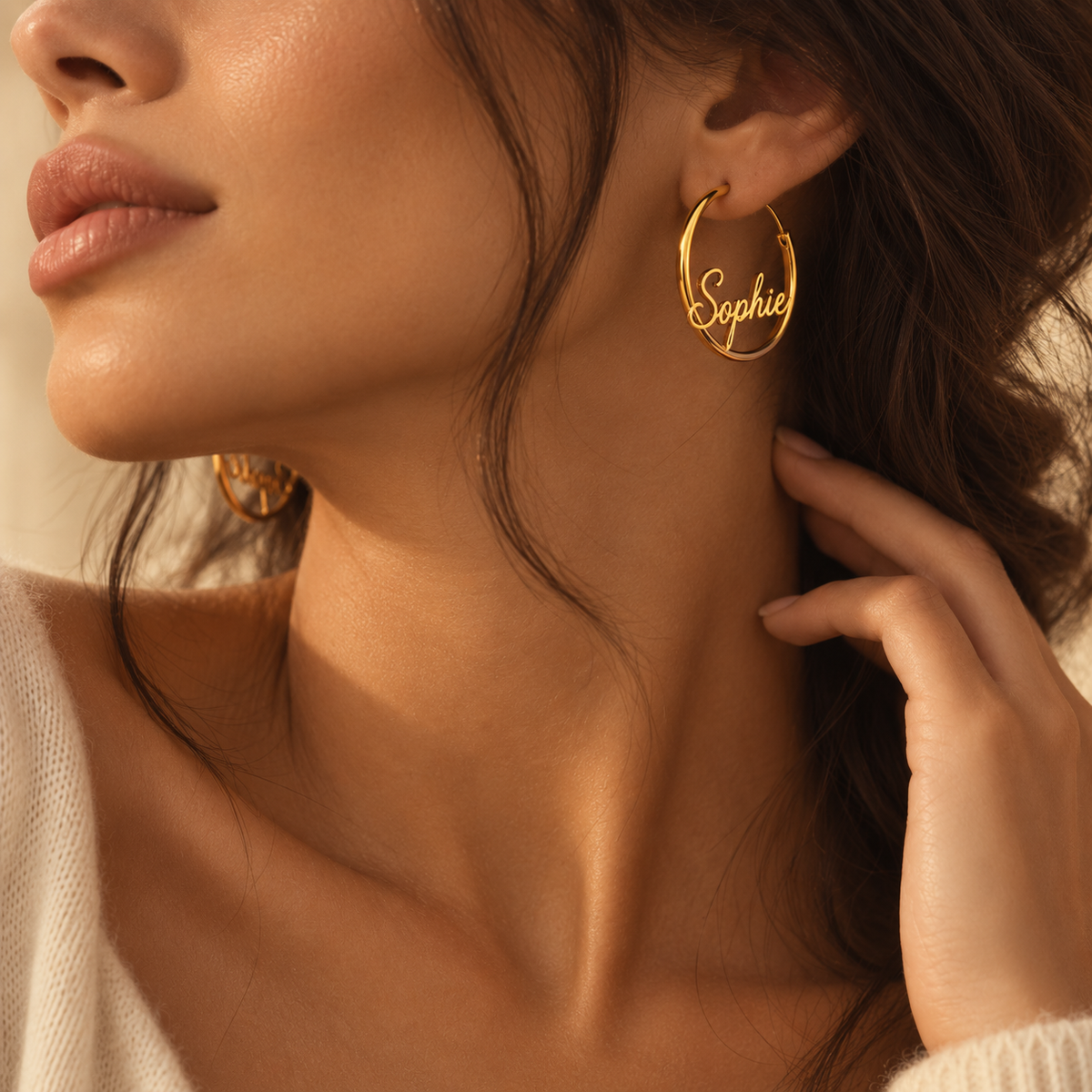 Close-up model wearing personalized gold name hoop earrings