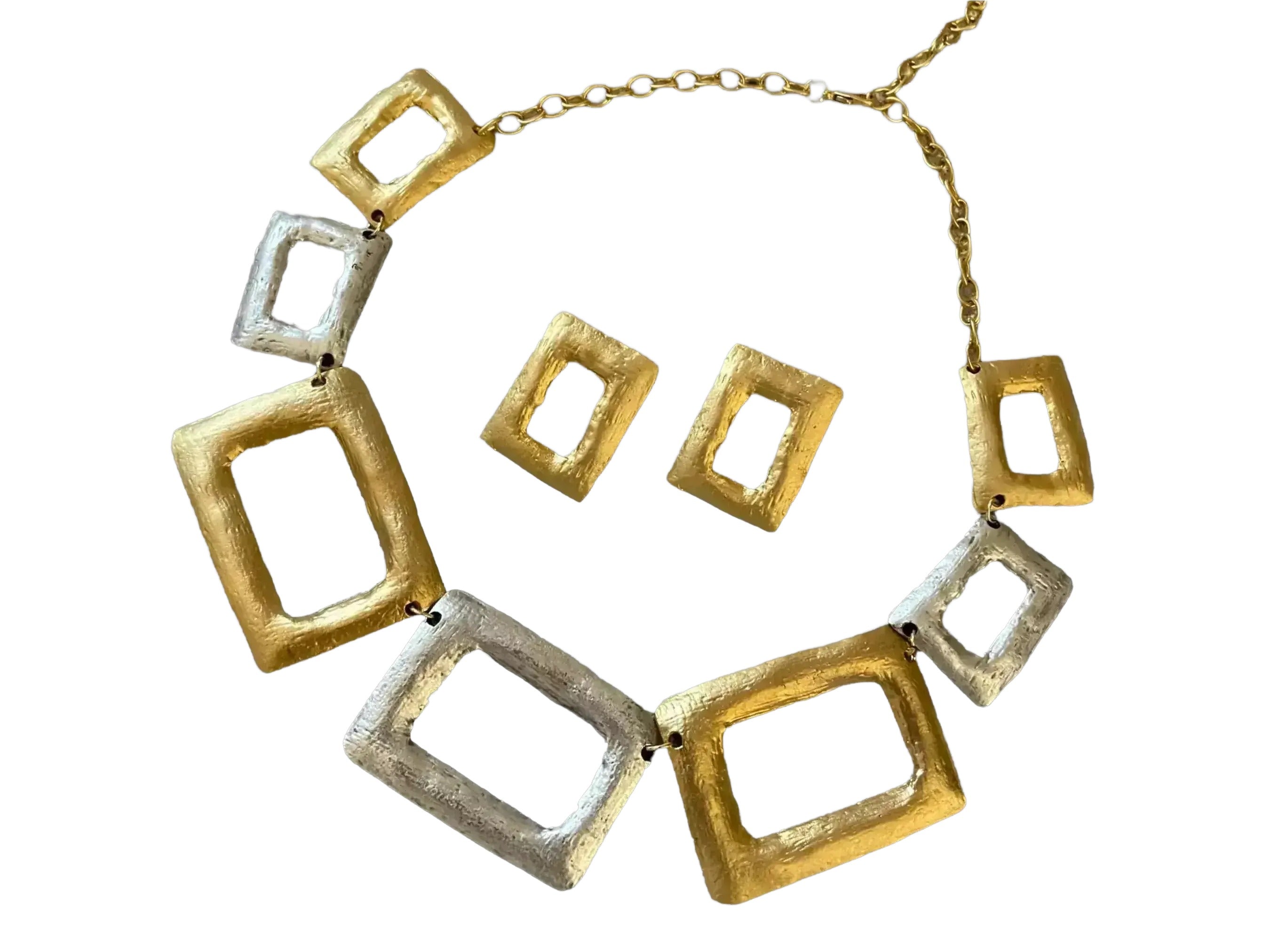 a necklace and earrings with a geometric design, consisting of various shapes and sizes of square and rectangular elements.