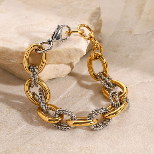 Thick chain with gold and color matching unique bracelet in a close-up wrist view