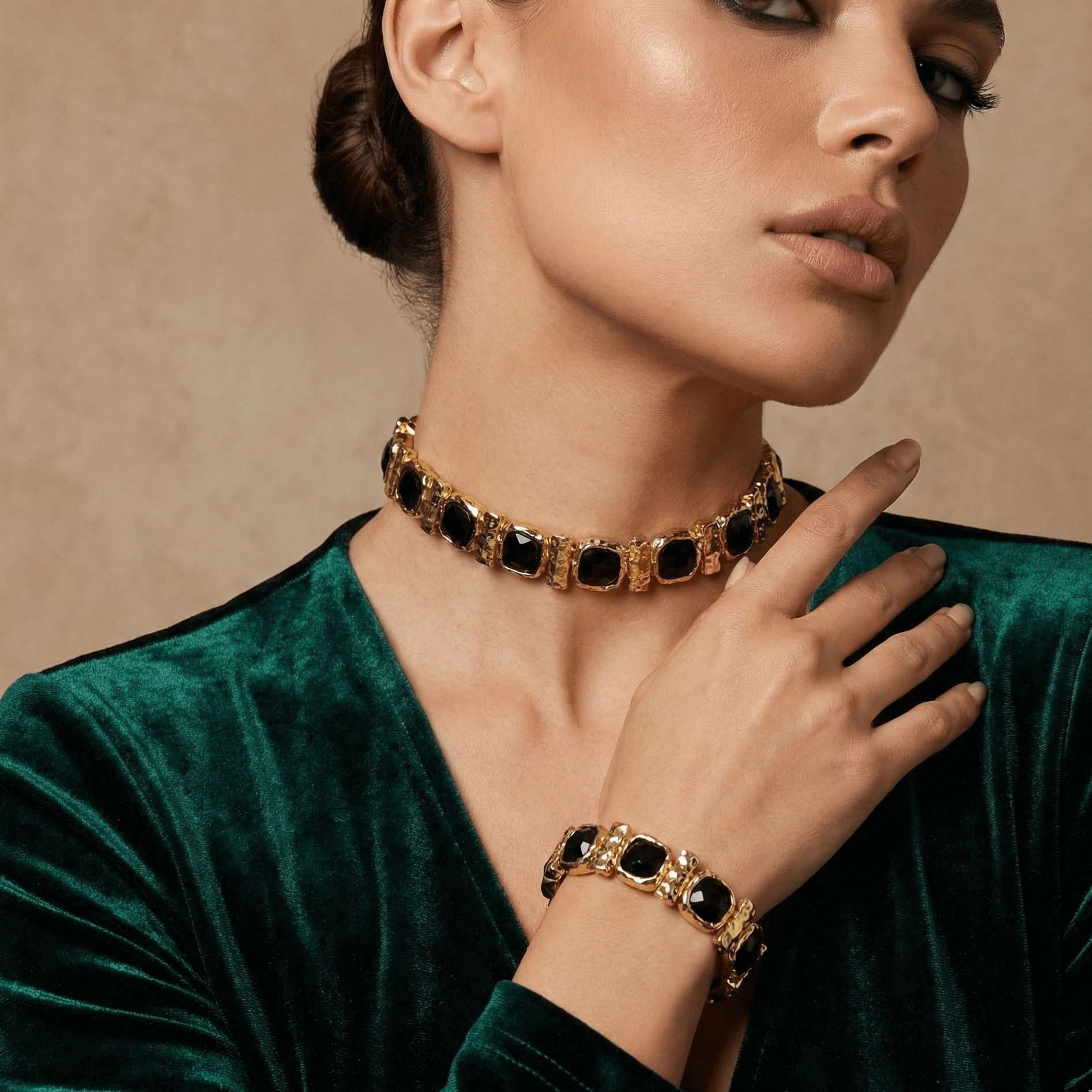 Woman wearing a gold and black choker and bracelet against a beige background