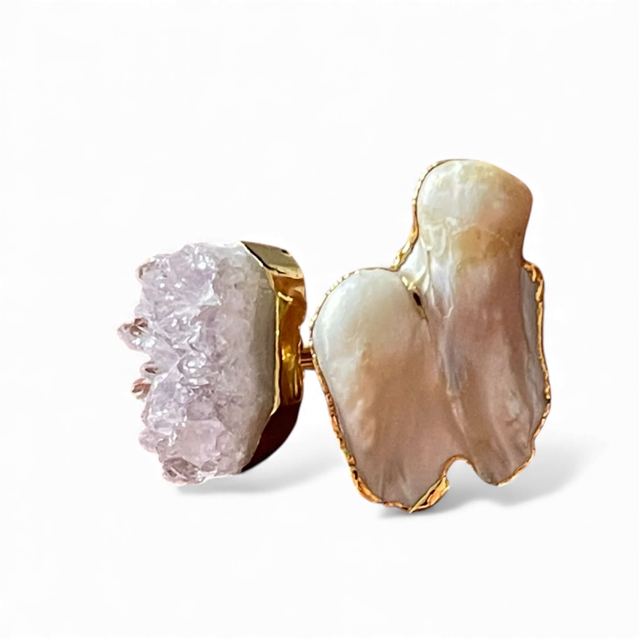 Close up of purple crystal and white pearl set in gold adjustable ring